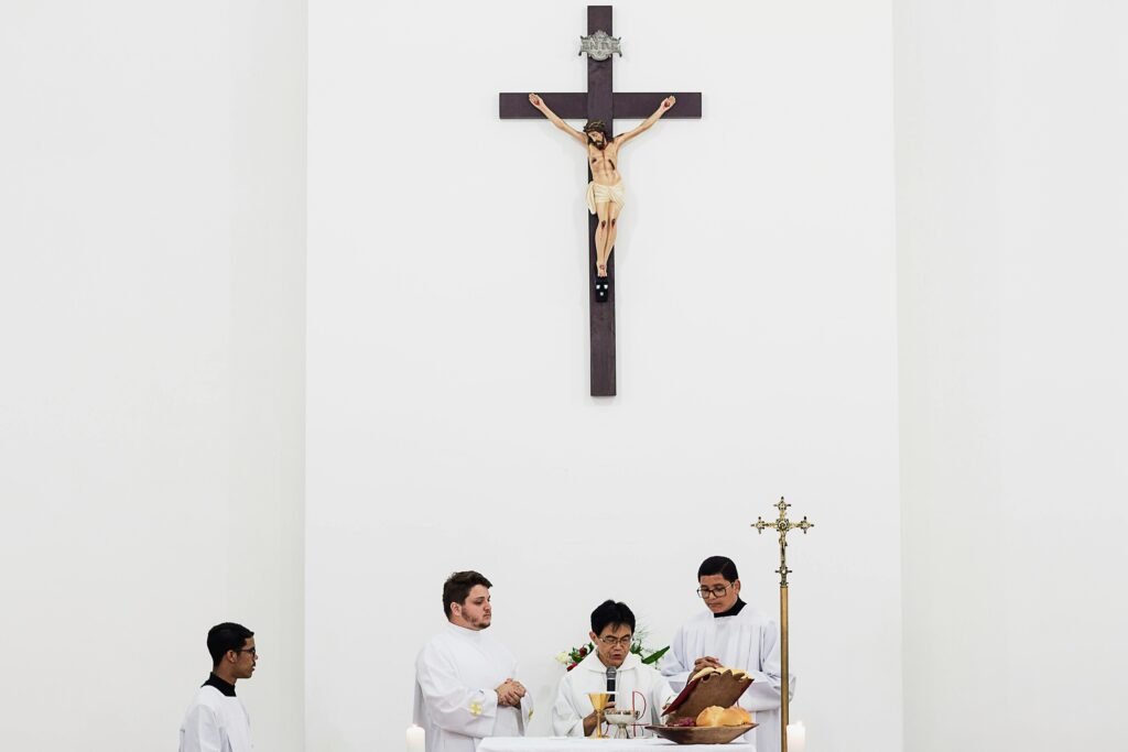 pexels-photo-1782330-1782330 Priests conducting a religious ceremony inside a church under a large crucifix.